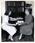 Dean Bush looking at pictures with a student, 1950 -- 1959